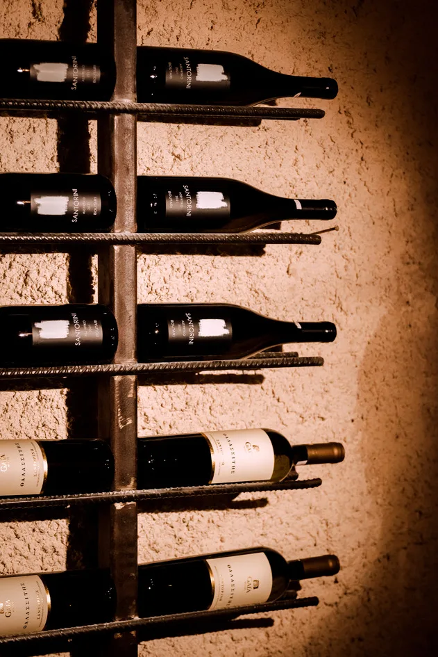 Santorini wine bottles in the racks at Madame Sousou