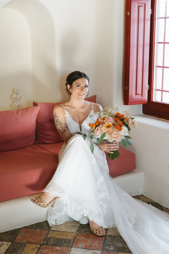 Andrea & Jordan wedding at Love Cave Venue, Santorini — the bride with her bouquet before the ceremony