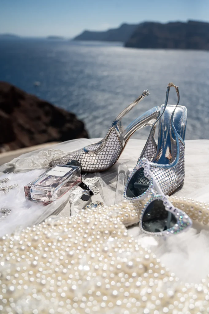 Crystal & Gabriel wedding at Love Cave Venue, Santorini — the bride’s heels and pearls above the caldera