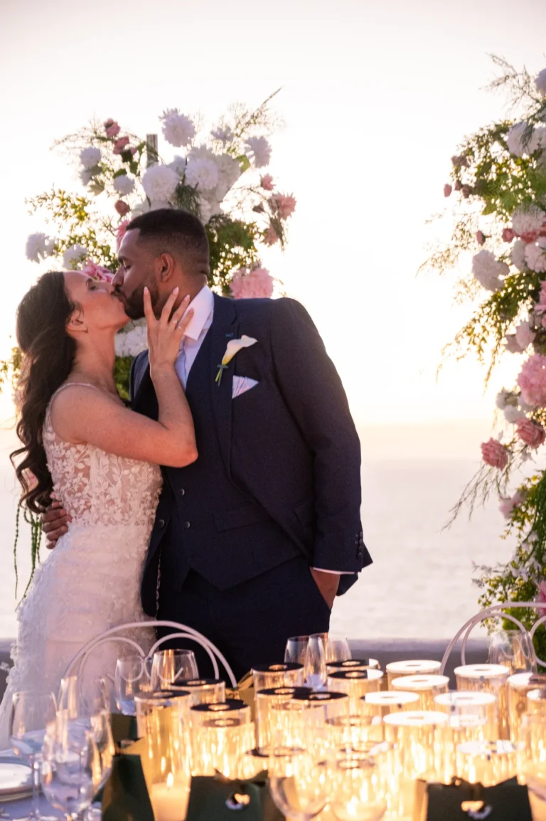 Crystal & Gabriel wedding at Love Cave Venue, Santorini — a kiss under the flowers