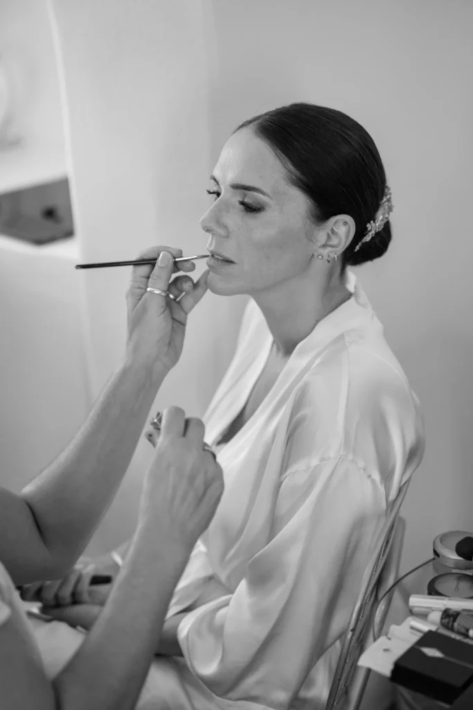 Elisa & Fabio wedding at Love Cave Venue, Santorini — the bride having her make-up done