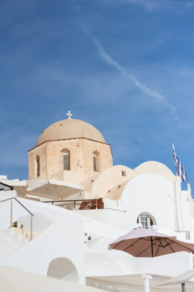 Holly & Taylor wedding at Love Cave Venue, Santorini — a church dome above Oia