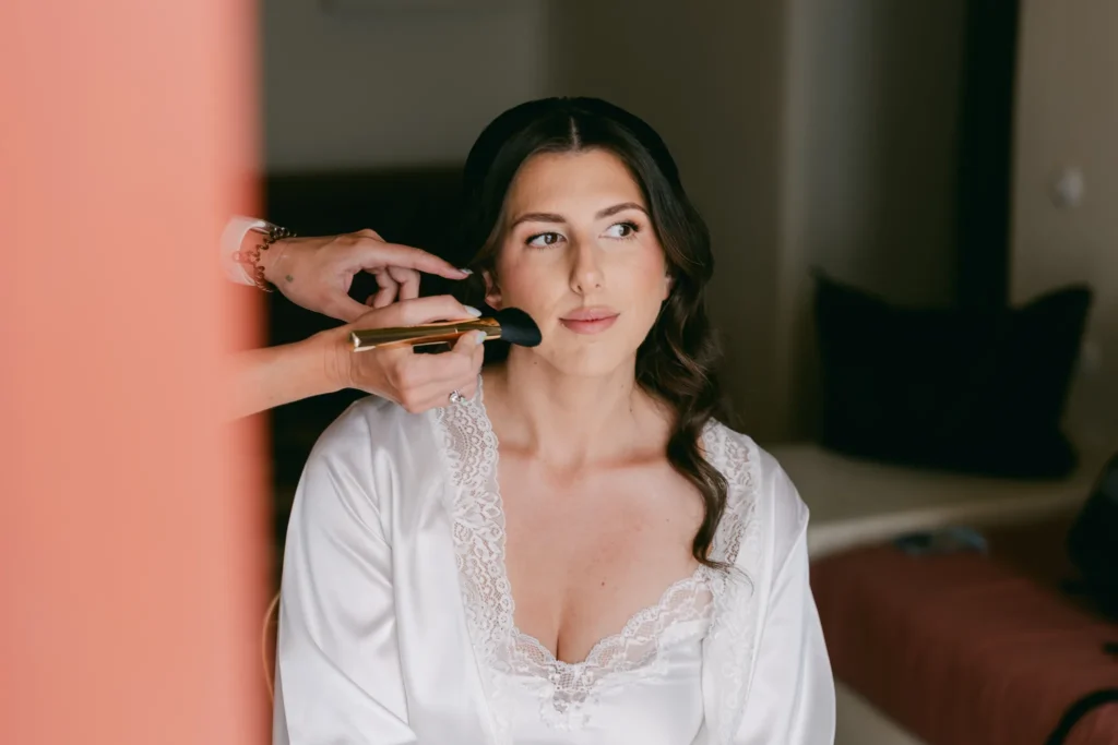 Loren & Matt wedding at Love Cave Venue, Santorini — the bride having her make-up done